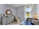 Bedroom with crib, dresser, and charming decor at 2638 Sage Valley Way, Winter Haven, FL 33884