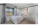 Bright bedroom with white bed frame and window views at 2638 Sage Valley Way, Winter Haven, FL 33884