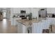 Modern kitchen with island, stainless steel appliances, and white cabinets at 2638 Sage Valley Way, Winter Haven, FL 33884