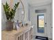 Bright entryway with decorative console table and large mirror at 2638 Sage Valley Way, Winter Haven, FL 33884