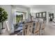 Bright dining room features a large table with seating for six and access to a patio at 2638 Sage Valley Way, Winter Haven, FL 33884