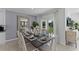 Bright dining room with table for six and sliding glass doors at 2638 Sage Valley Way, Winter Haven, FL 33884