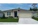 Single-story home with attached garage and landscaped lawn at 2638 Sage Valley Way, Winter Haven, FL 33884