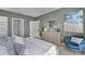 Spacious bedroom with dresser and blue accent chair at 2638 Sage Valley Way, Winter Haven, FL 33884