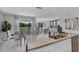 Open kitchen with island, views to dining area and pond at 2638 Sage Valley Way, Winter Haven, FL 33884