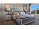 King-size bed in a bright bedroom with large window at 2634 Sage Valley Way, Winter Haven, FL 33884
