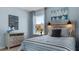 Bedroom with striped bedding and nautical artwork at 2634 Sage Valley Way, Winter Haven, FL 33884