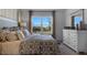 Elegant Primary bedroom with a patterned bedspread and large window at 2634 Sage Valley Way, Winter Haven, FL 33884