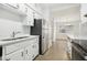 Modern kitchen with white cabinets, stainless steel appliances, and a double sink at 4221 Mizell St, Orlando, FL 32812