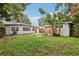 Back of house showing patio, shed and grassy backyard at 4221 Mizell St, Orlando, FL 32812