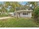 Cute house exterior with a covered porch and landscaping at 4221 Mizell St, Orlando, FL 32812