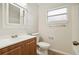 Clean bathroom with wood vanity and a window at 4221 Mizell St, Orlando, FL 32812