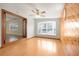 Bright living room featuring wood-look floors and a built-in wood accent wall at 4221 Mizell St, Orlando, FL 32812