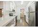 Clean and bright kitchen with white cabinets and stainless steel appliances at 4221 Mizell St, Orlando, FL 32812