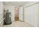 Laundry room with tiled floors, water heater and storage at 4221 Mizell St, Orlando, FL 32812