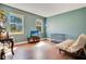 Common area with wood floors, couch, and dog crate at 2053 Nobscot Pl, Apopka, FL 32703