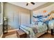 Serene bedroom with wood floors and mountain tapestry at 2053 Nobscot Pl, Apopka, FL 32703