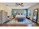 Bright bedroom with wood floors, ceiling fan, and large window at 2053 Nobscot Pl, Apopka, FL 32703