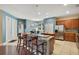 Modern kitchen with island, stainless steel appliances, and hardwood floor at 2053 Nobscot Pl, Apopka, FL 32703