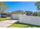 Attached garage with driveway and white fence at 2053 Nobscot Pl, Apopka, FL 32703