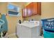 Bright laundry room, washer, dryer, and cabinets at 2053 Nobscot Pl, Apopka, FL 32703