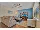 Spacious living room with L-shaped sofa, hardwood floors, and a large TV at 2053 Nobscot Pl, Apopka, FL 32703