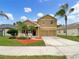 Two-story house with a two-car garage and landscaped yard at 10472 Eastpark Lake Dr, Orlando, FL 32832