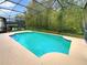 Screened-in pool with a large backyard at 10472 Eastpark Lake Dr, Orlando, FL 32832