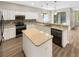 Modern kitchen with island, stainless steel appliances, and granite countertops at 10472 Eastpark Lake Dr, Orlando, FL 32832