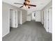 Large bonus room with grey carpet, ceiling fan, and multiple entry points at 10472 Eastpark Lake Dr, Orlando, FL 32832