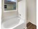 Bathroom with garden tub, shower, and vinyl flooring at 10472 Eastpark Lake Dr, Orlando, FL 32832