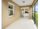 Screened porch with a view of the kitchen and backyard at 10472 Eastpark Lake Dr, Orlando, FL 32832