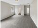 Well-lit bedroom with grey carpet and two windows at 10472 Eastpark Lake Dr, Orlando, FL 32832