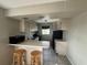 Kitchen with white cabinets, black appliances and breakfast bar at 5505 Hernandes Dr # 238, Orlando, FL 32808