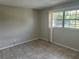 Simple bedroom with tile flooring and large window at 5505 Hernandes Dr # 238, Orlando, FL 32808