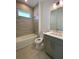 Bathroom with gray vanity, white toilet and bathtub at 58 Overleaf Ln, Orlando, FL 32839