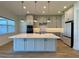 Bright kitchen boasts an expansive island, stainless steel appliances, and ample cabinetry at 58 Overleaf Ln, Orlando, FL 32839