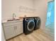 Convenient laundry room with washer, dryer, and utility sink at 58 Overleaf Ln, Orlando, FL 32839