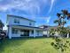 Two-story house with backyard, covered patio, and landscaping at 58 Overleaf Ln, Orlando, FL 32839