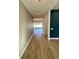 Long entry hallway with light wood floors, view to backyard at 58 Overleaf Ln, Orlando, FL 32839