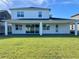 Two-story home with covered patio, grassy backyard, and modern design at 58 Overleaf Ln, Orlando, FL 32839