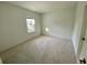 Well-lit bedroom featuring neutral carpeting and ample space at 58 Overleaf Ln, Orlando, FL 32839