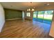 Spacious dining room with green accent wall and hardwood floors at 58 Overleaf Ln, Orlando, FL 32839