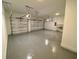Two-car garage featuring epoxy flooring and ample storage at 58 Overleaf Ln, Orlando, FL 32839