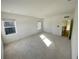 Bright and airy bedroom featuring neutral carpeting and plenty of natural light at 58 Overleaf Ln, Orlando, FL 32839