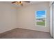 Well-lit bedroom with window, carpet, and closet at 3458 Bonnet Creek Pl, Kissimmee, FL 34746