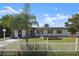 Newly renovated home with a white picket fence and manicured lawn at 2259 Howland Blvd, Deltona, FL 32738