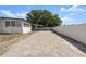 Side view of the home with paved driveway and fence at 2259 Howland Blvd, Deltona, FL 32738