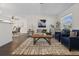 Living room features a neutral color palette, stylish seating, and large windows at 2259 Howland Blvd, Deltona, FL 32738