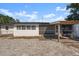 Rear exterior showcasing a patio and screened porch at 2259 Howland Blvd, Deltona, FL 32738